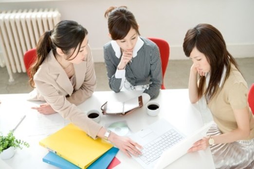 Three women having meeting at desk